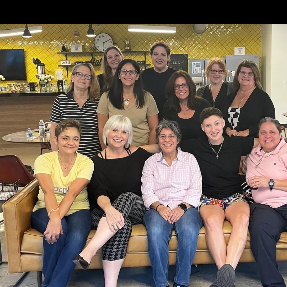 A Community Candle Co. class group holding finished candles