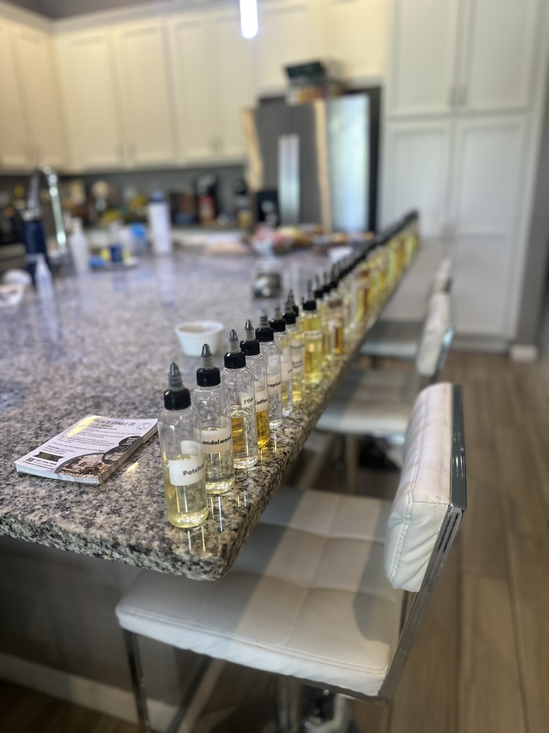 Private candle-making event table setup with glassware and supplies