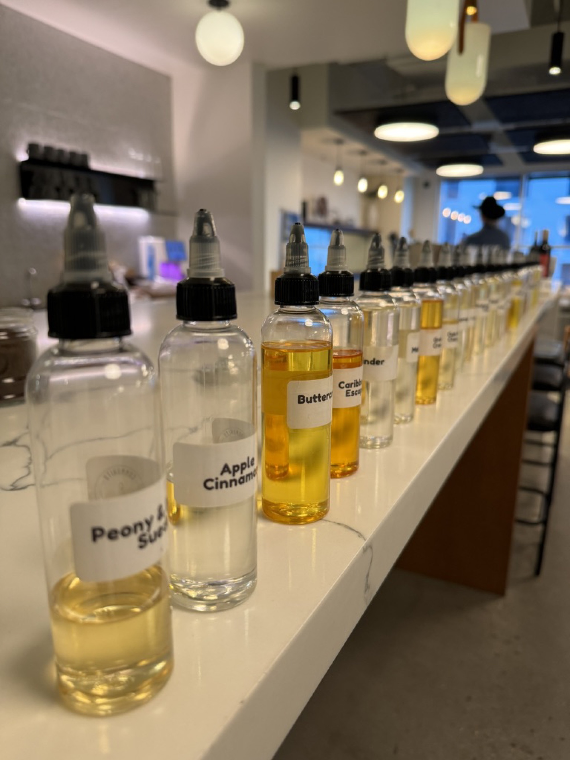 Rows of fragrance bottles ready for a mobile candle-making event