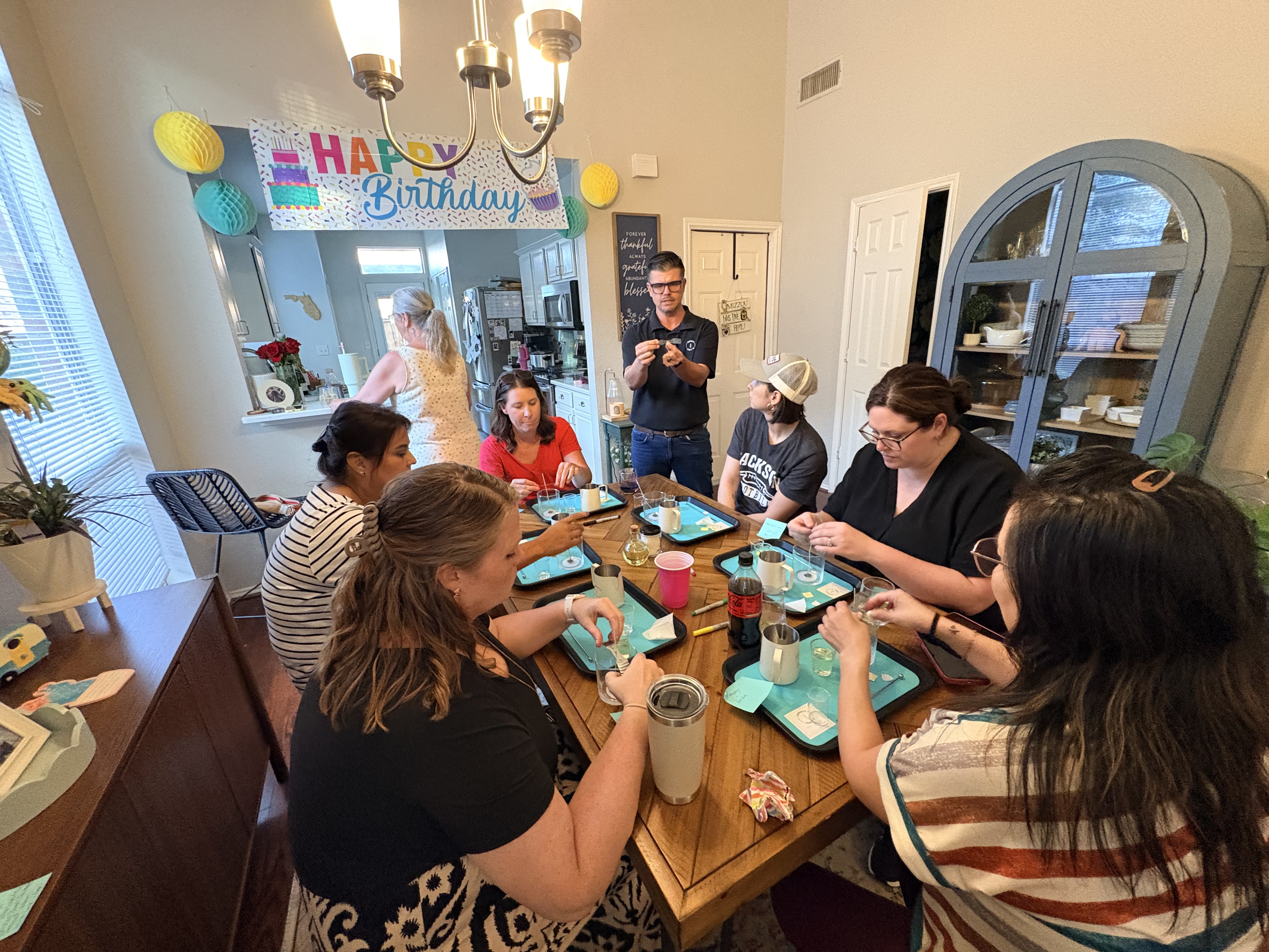 Hands finishing a custom candle during a guided candle-making class