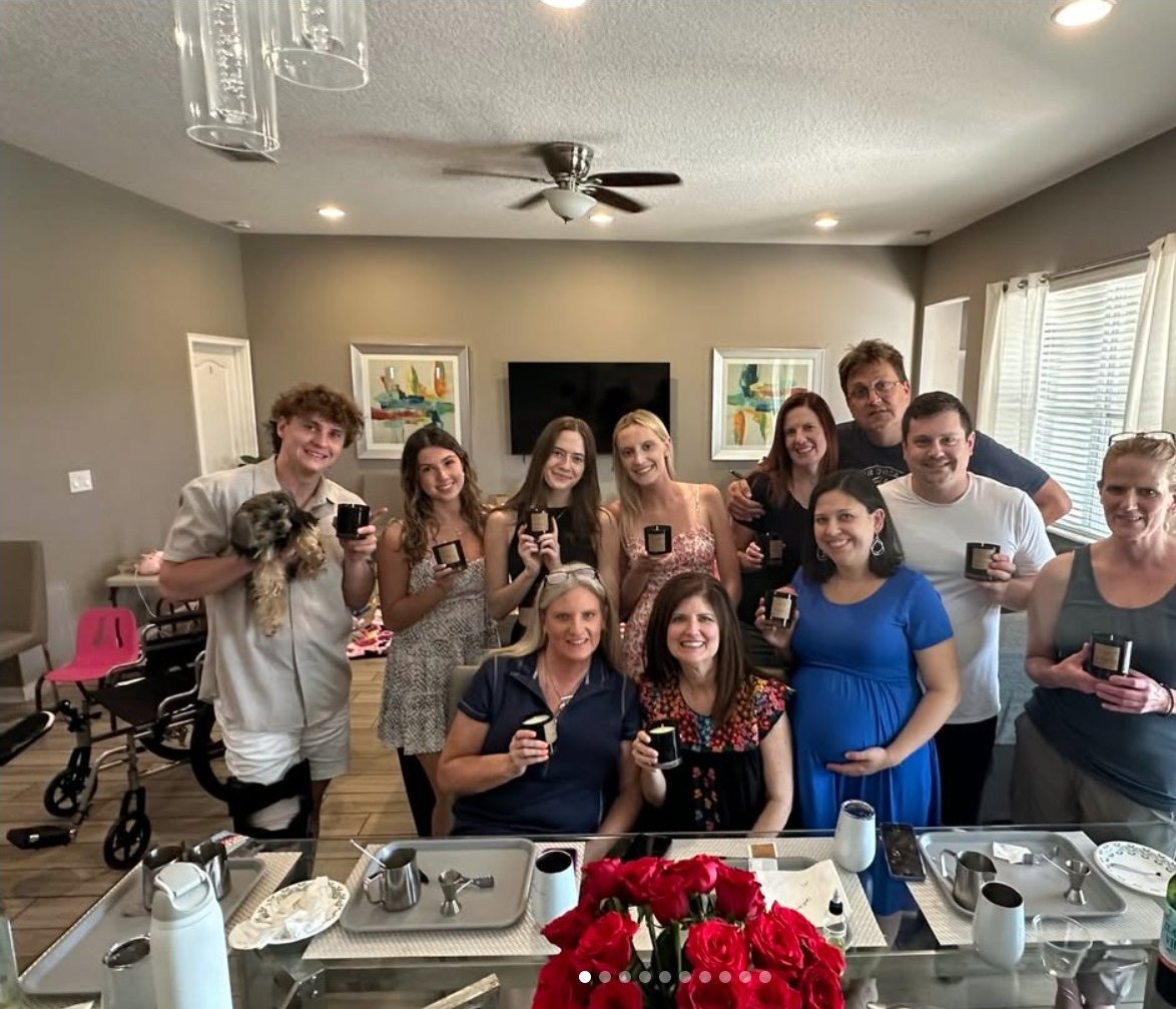 A private home candle-making group holding finished candles